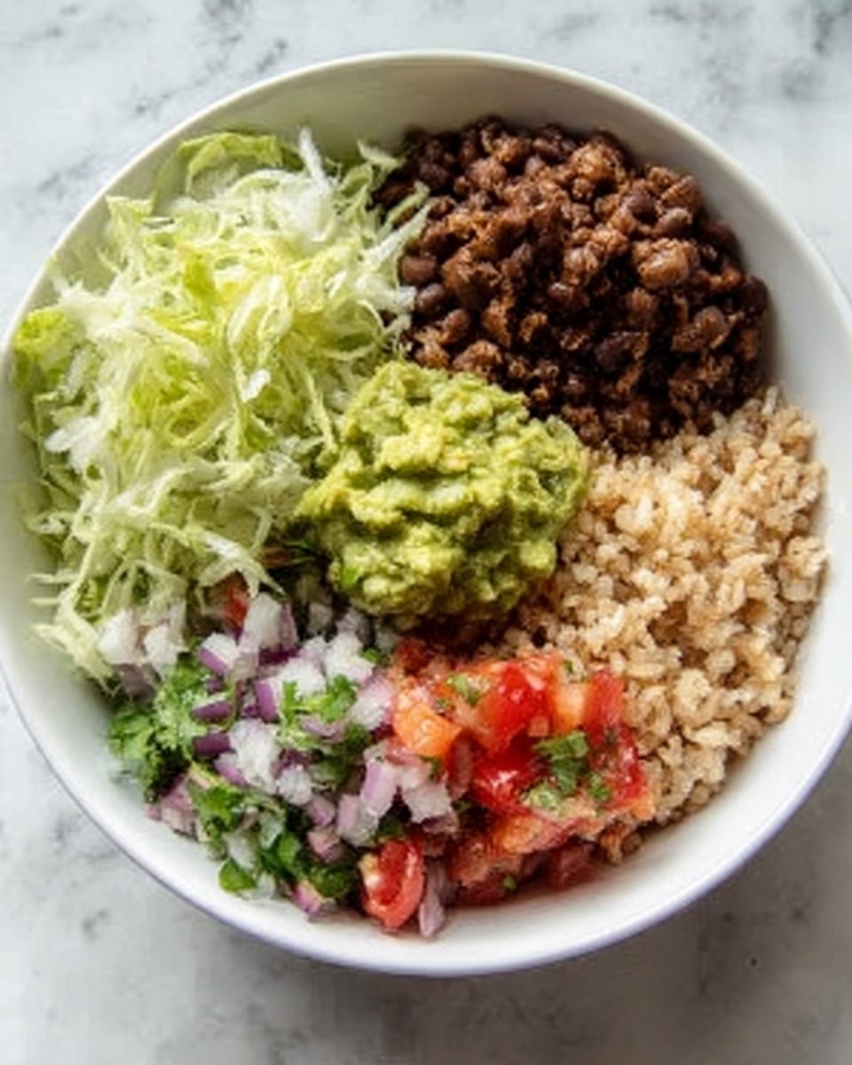 A white bowl with four layers of food arranged side by side inside. On the top left is shredded pale green lettuce with a soft texture. Next to it on the top right are dark brown cooked beans, rough and crumbly in texture. Below the beans on the right side is light brown cooked rice with a grainy texture. In the center of the bowl, covering parts of all three layers, sits a dollop of chunky bright green guacamole. Finally, the bottom left section has a colorful mixture of red diced tomatoes, chopped white and purple onions, and pieces of green cilantro, all fresh and finely chopped. The bowl is set against a white marbled surface. Photo taken with an iphone --ar 4:5 --v 7
