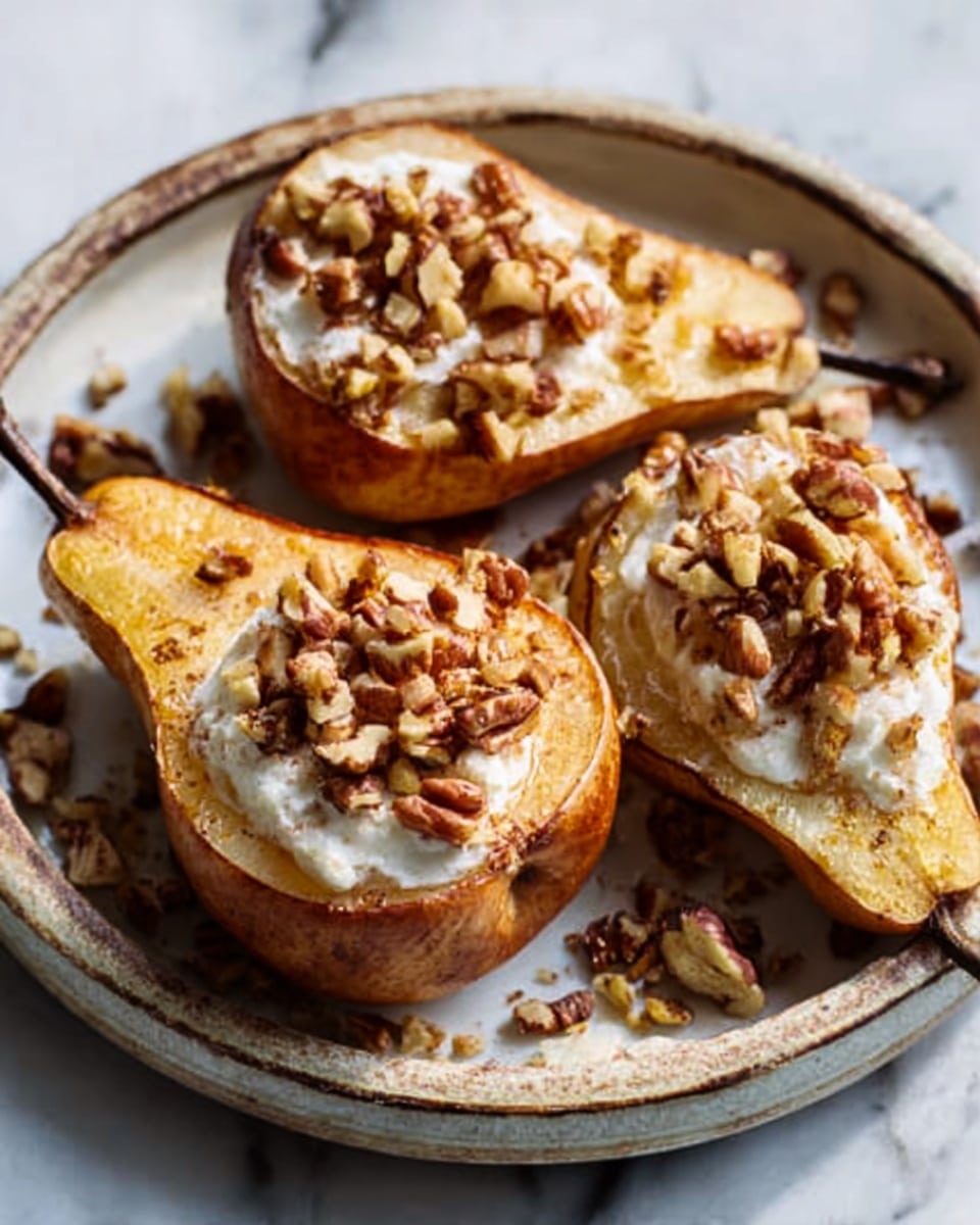 The image shows three baked pears on a large white plate with a rustic edge, each sliced in half and filled with a bright white creamy layer topped with small pieces of brown nuts, giving a crunchy texture. The pears are golden with a soft, cooked look, and the nuts scattered are unevenly spread, adding a natural feel. The plate sits on a white marbled surface, and the light creates soft shadows around the food, enhancing the warm colors and textures. Photo taken with an iphone --ar 4:5 --v 7