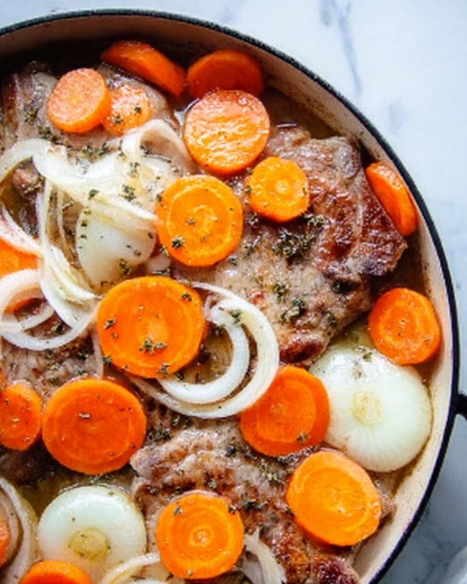 The image shows a close-up of cooked pork chops in a white pan, topped with sliced orange carrots and white onion rings. The pork chops are browned with a slightly crispy texture on the edges. The carrot slices are spread evenly across the meat, adding bright orange spots, while the onion rings are thin and translucent, layered over the pork and carrots. The background surface under the pan has a white marbled texture. photo taken with an iphone --ar 4:5 --v 7