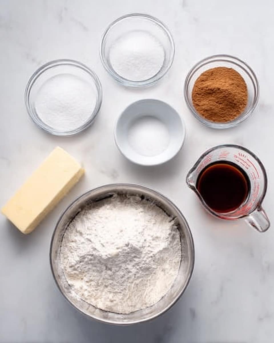 The image shows several glass bowls and a white measuring cup arranged neatly on a white marbled surface. In the middle bottom, there is a large silver bowl filled with white flour, showing a soft and powdery texture. Above it, to the left, a small glass bowl contains granulated white sugar, smooth and sparkly. To the right of the sugar bowl, there is a smaller glass bowl holding ground cinnamon, with a fine powder and a warm brown color. On the right side, a clear measuring cup filled with a dark brown liquid, likely molasses or syrup, is placed. To the left, a small white bowl holds a white powder, possibly baking soda or salt. At the bottom left, a stick of butter with a pale yellow color rests on the surface. Everything is positioned cleanly, with soft natural light and clear focus. Photo taken with an iphone --ar 4:5 --v 7