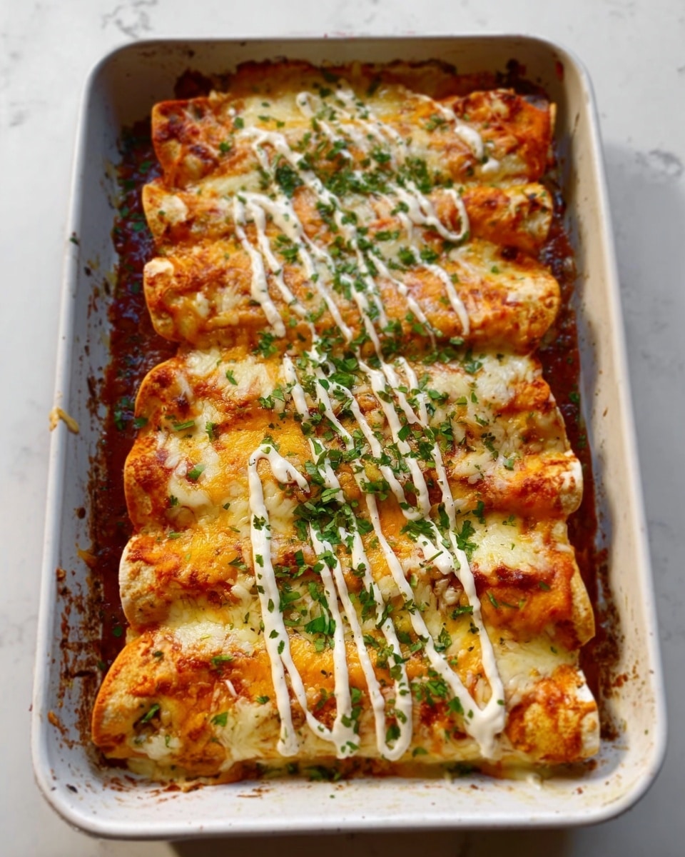 The image shows a white baking tray filled with four rolled enchiladas lined up side by side. Each enchilada is covered with melted light orange cheese that looks stringy and slightly browned in spots. A creamy white sauce is drizzled in curved lines on top of the cheese layer, with chopped green herbs sprinkled evenly across the dish. The tray rests on a white marbled surface. photo taken with an iphone --ar 4:5 --v 7