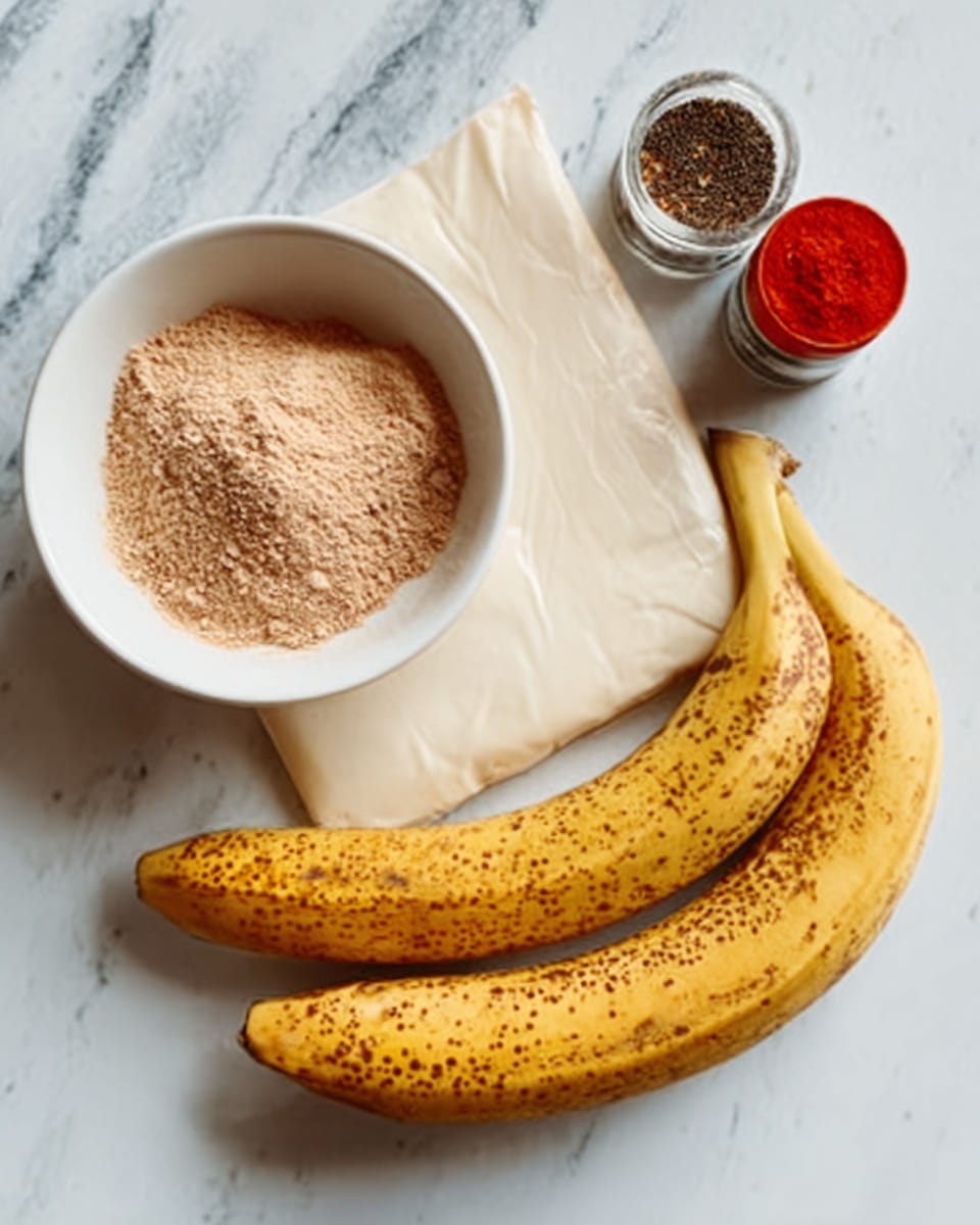 A white bowl filled with light brown powder sits on a white marbled surface, next to a small red spice container and a black and white spice grinder. Below these items, there is a flat, smooth layer of white cream or sauce spread out on the surface. To the right of the cream, there are two ripe bananas with brown spots on their yellow skin. photo taken with an iphone --ar 4:5 --v 7