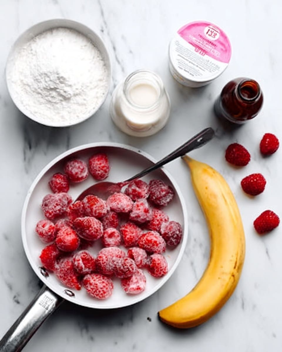 A white saucepan filled with bright red frozen raspberries sits on a white marbled surface. To the left, there is a white bowl filled with white powder and a silver spoon resting in it. Next to the bowl is a white container of yogurt with a pink label. At the top center, a clear glass bottle filled with milk sits beside a small dark brown bottle. To the right, a peeled banana lies on the surface with the peel curling to the side, and several frozen raspberries are scattered nearby. photo taken with an iphone --ar 4:5 --v 7