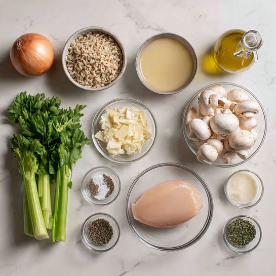 The image shows a neat arrangement of raw ingredients on a white marbled surface for cooking a dish. At the center is a clear bowl with raw chicken pieces (thighs or breasts). To the right, a medium clear bowl is filled with small white mushrooms, and next to it is a clear glass container holding pale yellow broth. Above is a clear bowl with long-grain white rice. On the left side, there are three long, green celery sticks, a bunch of fresh green parsley with leaves, and several small clear bowls holding minced garlic, black pepper, dried oregano, salt, a creamy white sauce, and grated light yellow cheese. Behind these, a whole light brown onion and a small glass bottle with yellow olive oil are placed. The overall colors are soft whites, greens, pale pink, light yellows, and natural browns. photo taken with an iphone --ar 4:5 --v 7