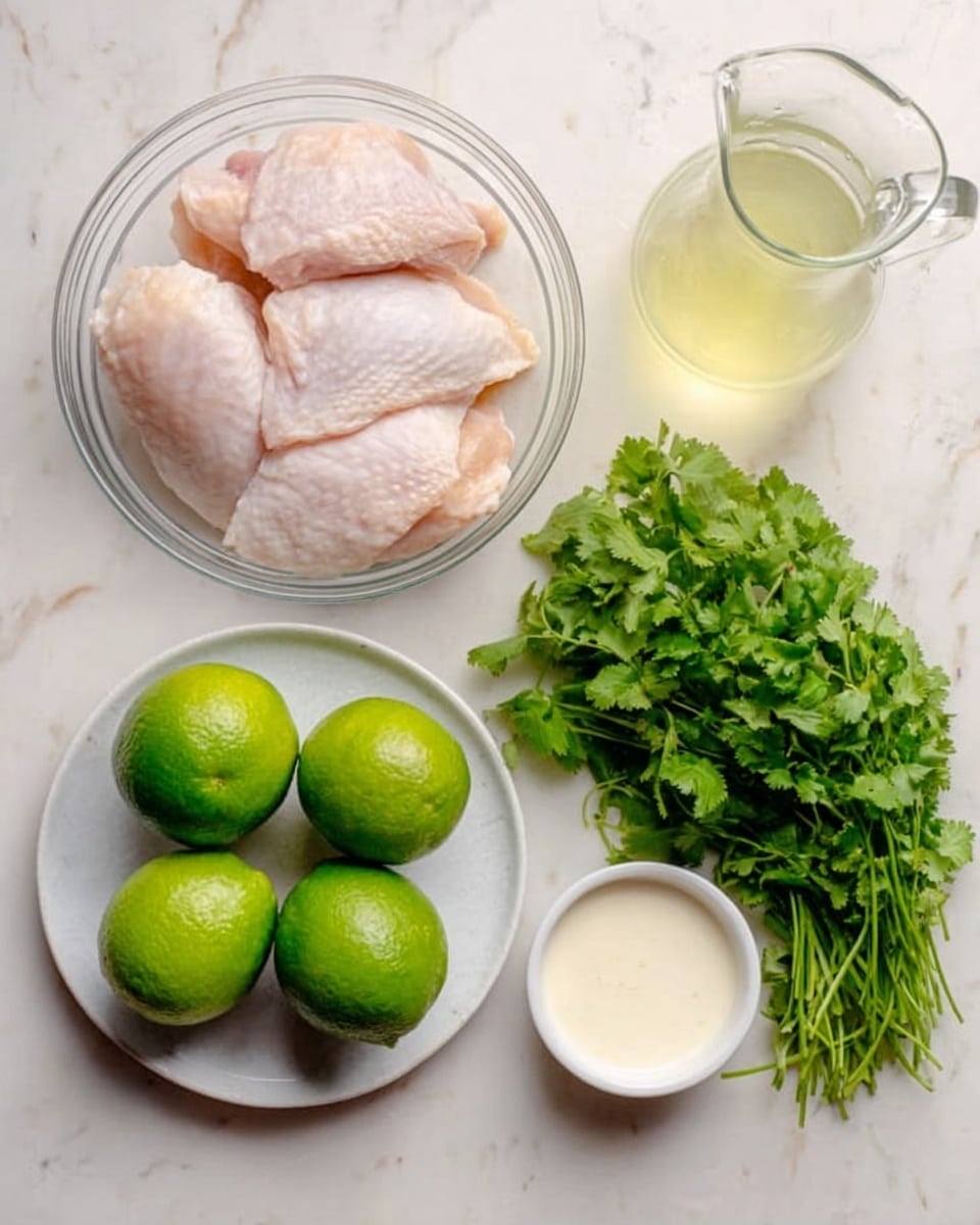 The image shows raw chicken pieces placed on a transparent bowl at the top left. Below the bowl, there are three whole green limes with smooth skin. At the bottom right, a white plate holds a bunch of fresh green cilantro with visible leafy texture. Near the top right, there is a clear glass pitcher filled with light yellow liquid. Lastly, a small white bowl containing a creamy white sauce sits near the limes, all arranged on a white marbled surface. Photo taken with an iphone --ar 4:5 --v 7