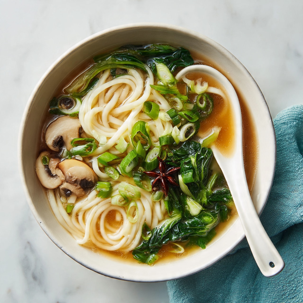 A serving suggestion for Tonyuu Zosui in a white bowl with green onions and mushrooms as garnish.