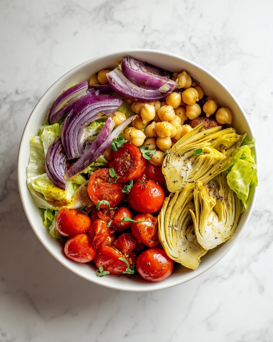 A white bowl filled with a colorful salad featuring several layers: the bottom layer has green herbs scattered throughout, followed by chickpeas with a pale beige color, then slices of creamy yellow artichoke. On top, there are bright red grape tomatoes cut in half and thin slices of purple-red onion arranged evenly. The textures range from smooth artichoke pieces to the round, firm chickpeas and crisp tomatoes, all set against a white marbled surface. The photo is taken with an iphone --ar 4:5 --v 7