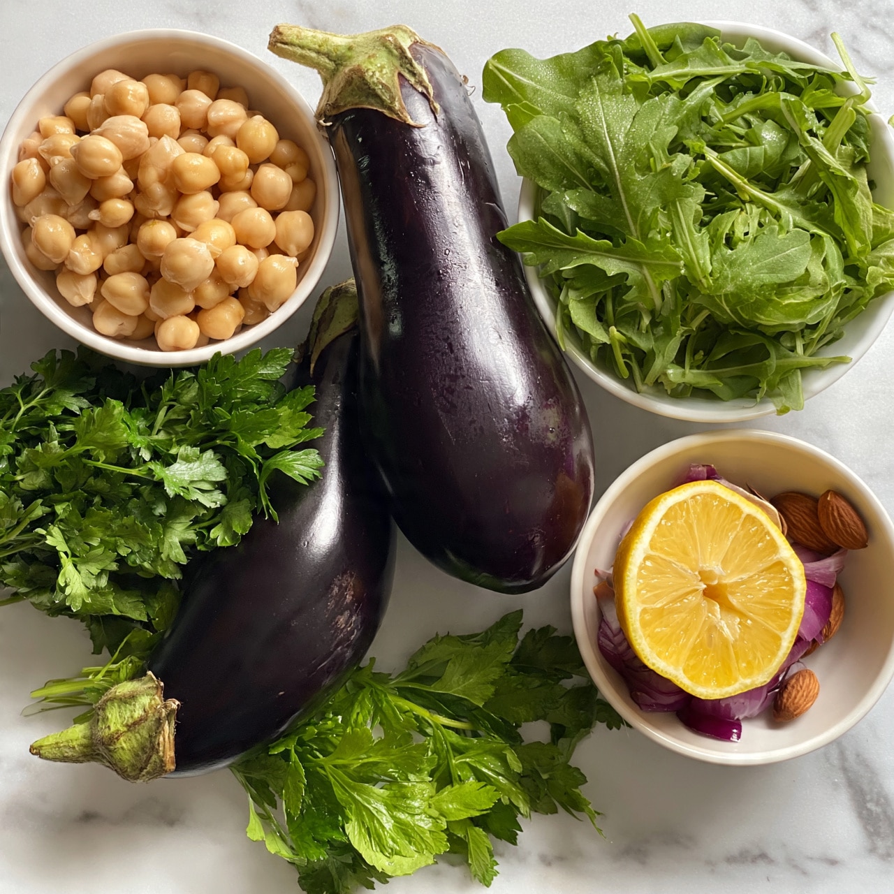 square image The image shows two large, shiny dark purple eggplants placed on a white marbled surface. Next to them, there is a small white bowl filled with round, light beige chickpeas, and a bunch of green fresh parsley lies beside the eggplants. There is also a white bowl with green arugula leaves, which look fresh and slightly curly. Another small white bowl holds a bright yellow lemon cut in half, some red onion pieces, and a few brown almonds. The scene is bright and clean, with all items arranged clearly on the white marbled surface. Photo taken with an iphone --ar 4:5 --v 7