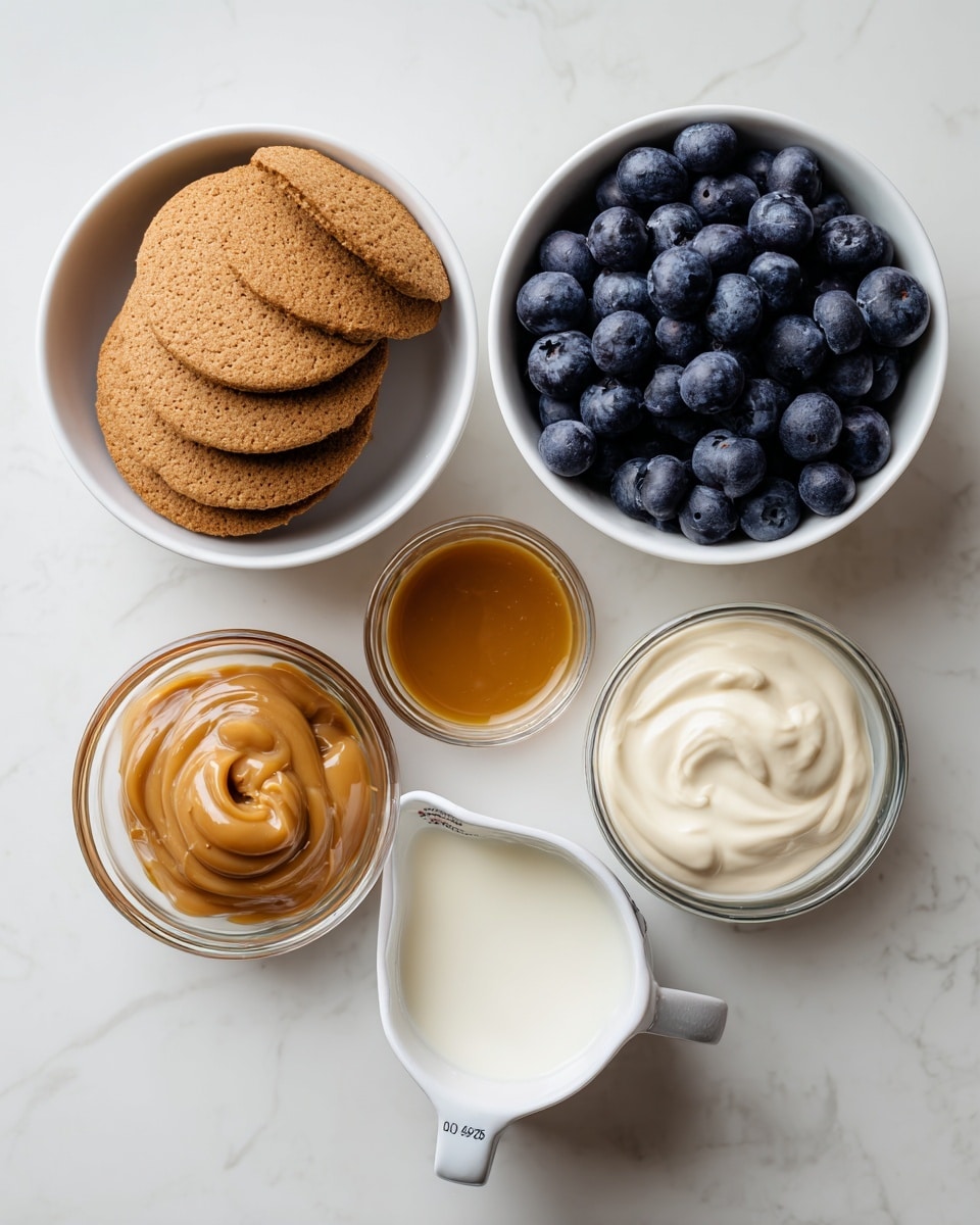 The image shows four white bowls placed on a white marbled surface. The top left bowl contains round, brown biscuits stacked inside. To the right, there is a bowl filled with fresh, dark blue blueberries. Below the biscuits, a small glass container holds thick, golden caramel sauce. At the bottom, there is a white measuring cup filled with creamy white milk. The setting is simple and clean with each item spaced apart neatly. Photo taken with an iphone --ar 4:5 --v 7