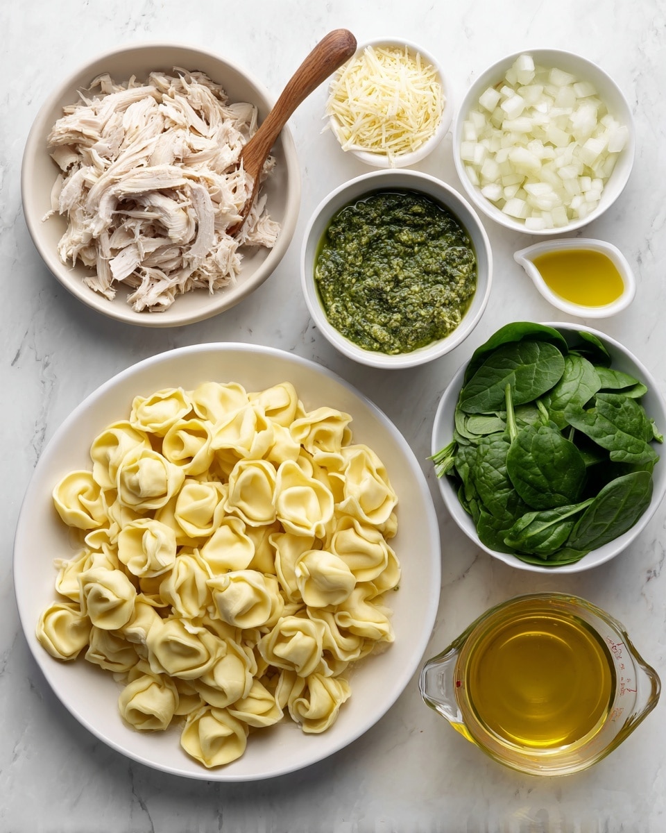 The image shows six bowls and a glass measuring cup arranged on a white marbled surface. In the center is a large white plate filled with yellow tortellini pasta. Above it, slightly to the left, is a white bowl of shredded cooked chicken with beige and light brown tones. Next to that, a white bowl contains green pesto sauce with a wooden spoon. To the right of the pesto, a white bowl holds a fine pale yellow grated cheese. Below the cheese bowl, a small white cup contains golden olive oil. Below the large plate of tortellini to the left is a white bowl full of fresh dark green spinach leaves. At the bottom right, the clear glass measuring cup is filled with golden chicken broth. At the upper right, a white bowl contains chopped white onions. All items are brightly lit. Photo taken with an iphone --ar 4:5 --v 7