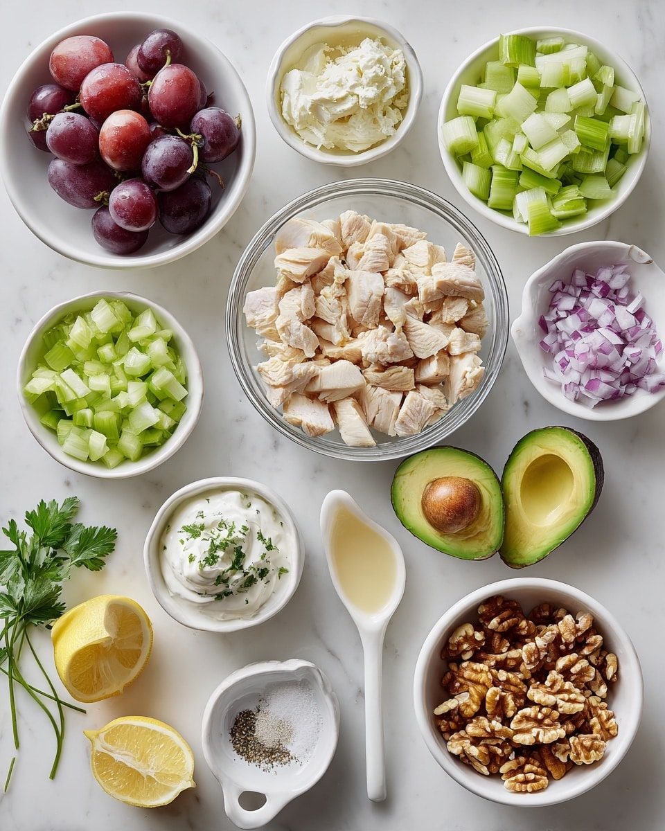 A white marble surface holds several small white bowls and glass bowls arranged neatly. In the center, a clear glass bowl contains chopped light beige cooked chicken pieces. Surrounding it are bowls with pale green diced celery, deep red halved grapes, bright green avocado cut in half showing the smooth flesh and large pit, and a white bowl filled with chopped brown walnuts. Smaller white bowls hold white sour cream, pale yellow mayonnaise, finely chopped purple-red onion, fresh green parsley leaves, and a lemon cut in half showing the yellow inside. Two tiny white dishes have a pale mustard-yellow sauce, coarse salt crystals, and ground black pepper. A white spoon rests inside one small dish with sauce. Everything is well spaced and brightly lit. Photo taken with an iphone --ar 4:5 --v 7