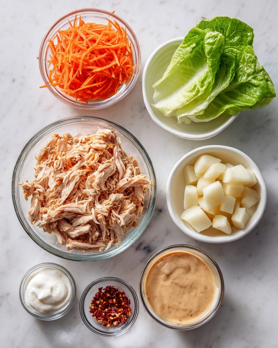 The image shows seven bowls on a white marbled surface, each holding a different ingredient. In the center is a large clear glass bowl filled with shredded light brown cooked chicken. To the left of this bowl is a small clear glass bowl with shredded bright orange carrots, and below that is a fresh, green leaf of lettuce. Above and to the right of the chicken bowl is a white bowl with small chunks of pale beige potatoes or jicama. Next to it on the right is another white bowl with a light brown sauce that looks smooth with some small bits in it. Below the sauce is a small clear glass bowl with a creamy white dollop, possibly sour cream or yogurt. Finally, near the shredded carrots is a tiny clear glass bowl with red chili flakes. The photo taken with an iphone --ar 4:5 --v 7