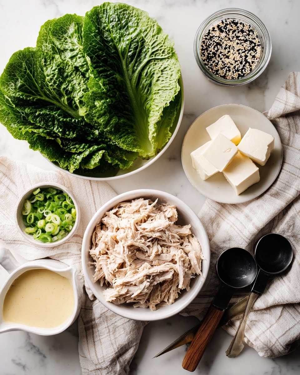The image shows several bowls and containers arranged on a white marbled surface with a beige striped cloth beneath some items. In the center, a white bowl contains shredded light beige chicken meat with a soft texture. Above it, a medium white bowl holds large dark green lettuce leaves with visible veins and a fresh look. To the top right, a small black measuring cup holds two small white cubes of butter, sitting near a small glass jar filled with mixed black and white sesame seeds, with a black measuring spoon resting on top. To the left of the butter, a small white bowl contains chopped light green spring onions. Below the spring onions, a small white jug with a spout contains a creamy, pale yellow liquid sauce. The overall setup is clean and bright with natural lighting. photo taken with an iphone --ar 4:5 --v 7