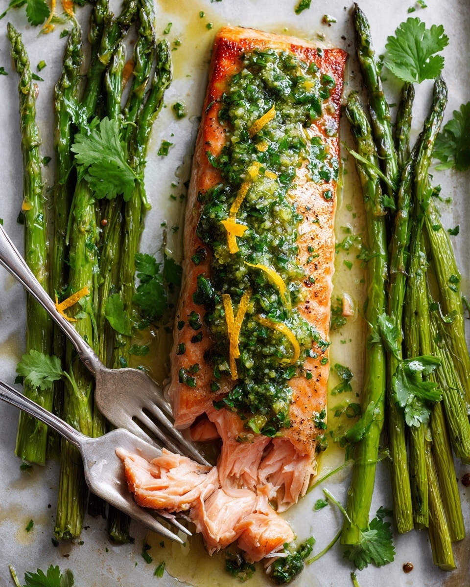 The image shows a cooked salmon fillet with a crispy brown surface topped with bright green herb sauce and orange zest pieces, surrounded by vibrant green asparagus stalks on a white marbled surface. The salmon is partially broken to show the soft pink inside. Fresh cilantro leaves are scattered on top of the salmon and asparagus, adding a fresh green touch. A silver fork leans on the side of the tray, suggesting serving. photo taken with an iphone --ar 4:5 --v 7