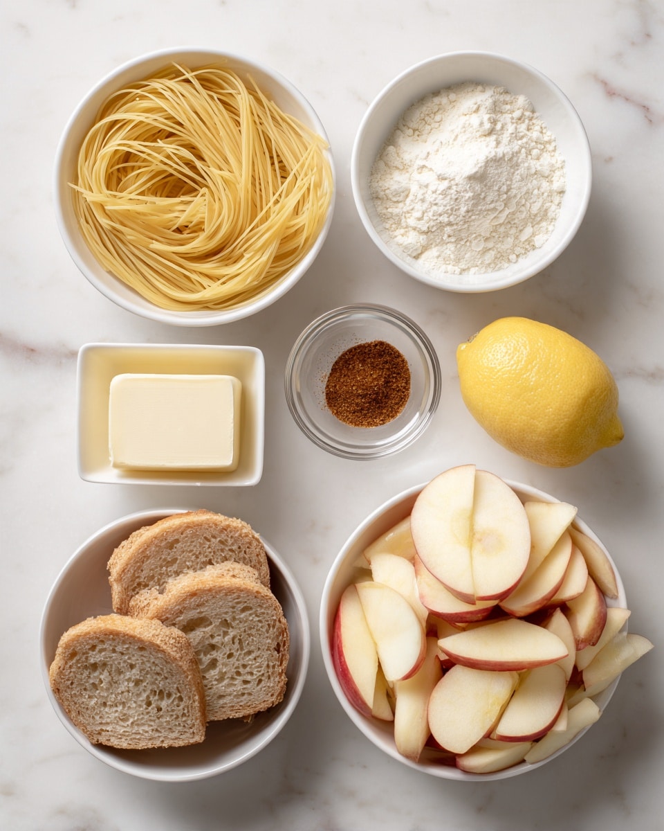 The image shows a white marbled surface with six containers holding different food items. At the top left, there is a white bowl filled with thin yellow uncooked pasta. Next to it on the right is a small white bowl with white flour. Below it is a tiny glass dish with a small amount of brown spice. To the right is a halved yellow lemon with one half resting cut side up on the surface. Below the spice is a small glass square container with a pale yellow piece of butter. On the bottom left, there is a white bowl filled with sliced light brown round bread pieces. On the right side is a large white bowl filled with thinly sliced pale cream-colored apples with red skin edges. photo taken with an iphone --ar 4:5 --v 7