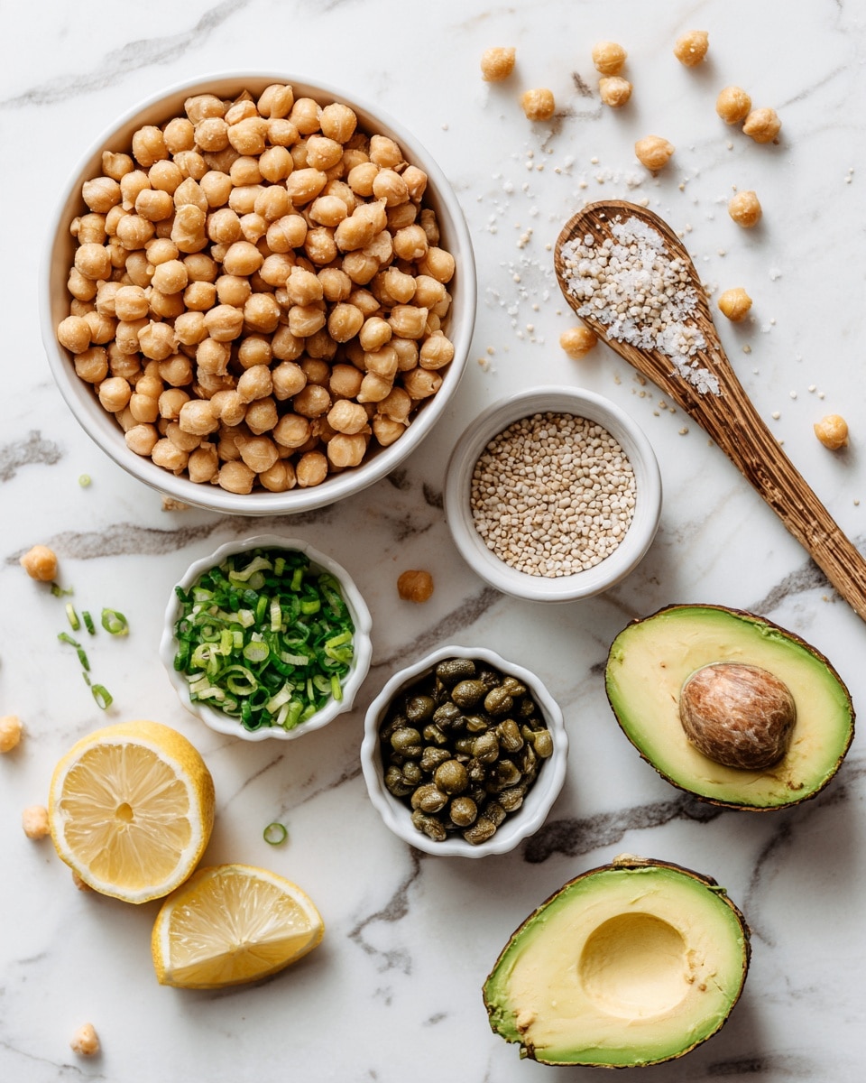 The image shows a white bowl full of round, light brown chickpeas in the top left area. Below and to the right are small white dishes; one contains small green pieces, another has green chopped onions, and a third small bowl has dark green capers. A wooden spoon filled with tiny white seeds or salt rests near the small dishes. There are two avocado halves with green flesh and brown seeds, one whole avocado, and a lemon cut in half and partly shown at the bottom left. All items sit on a white marbled surface. photo taken with an iphone --ar 4:5 --v 7